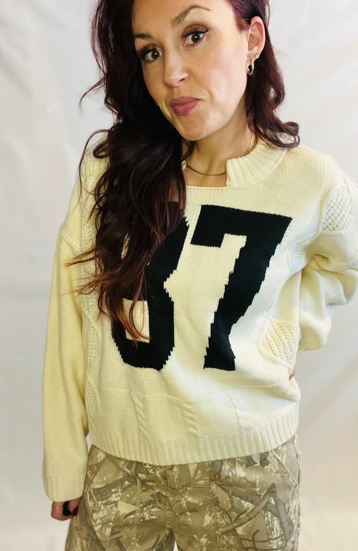 Cream oversized knit sweater with black 87 graphic and casual streetwear styling
