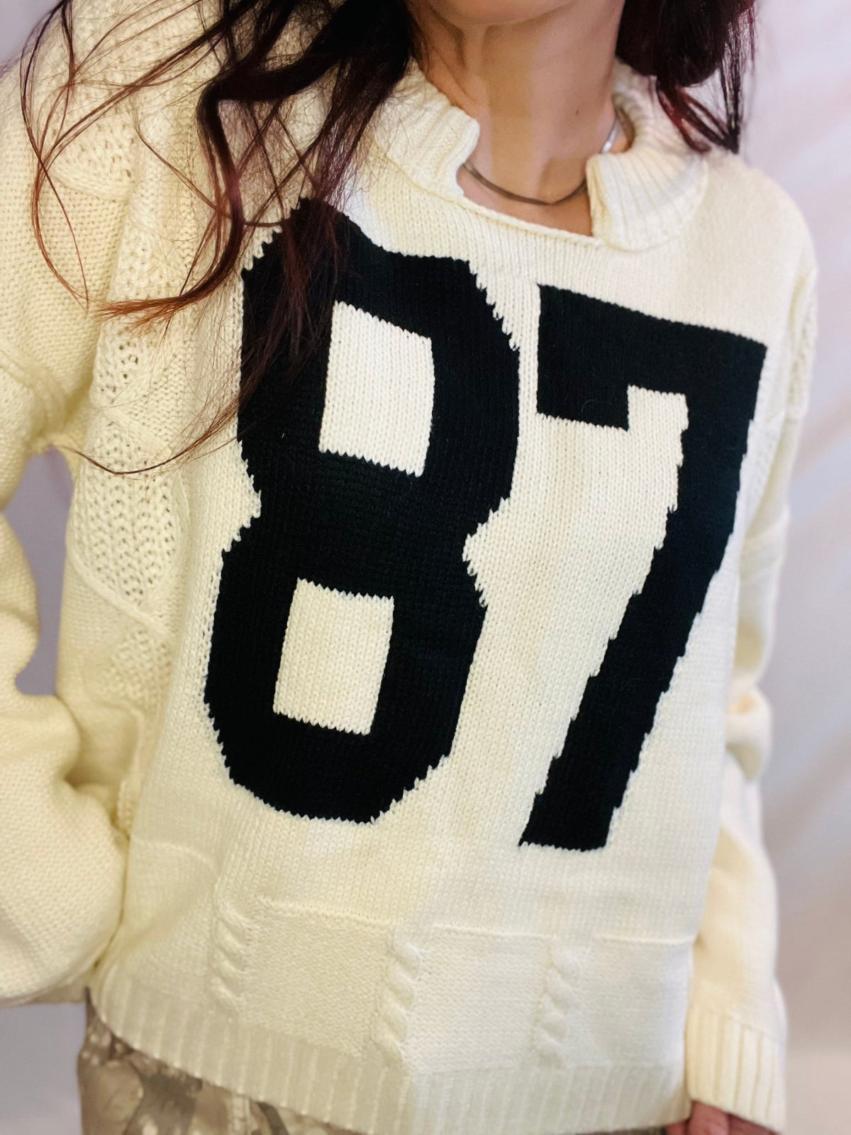 Cream oversized knit sweater with black 87 graphic and casual streetwear styling