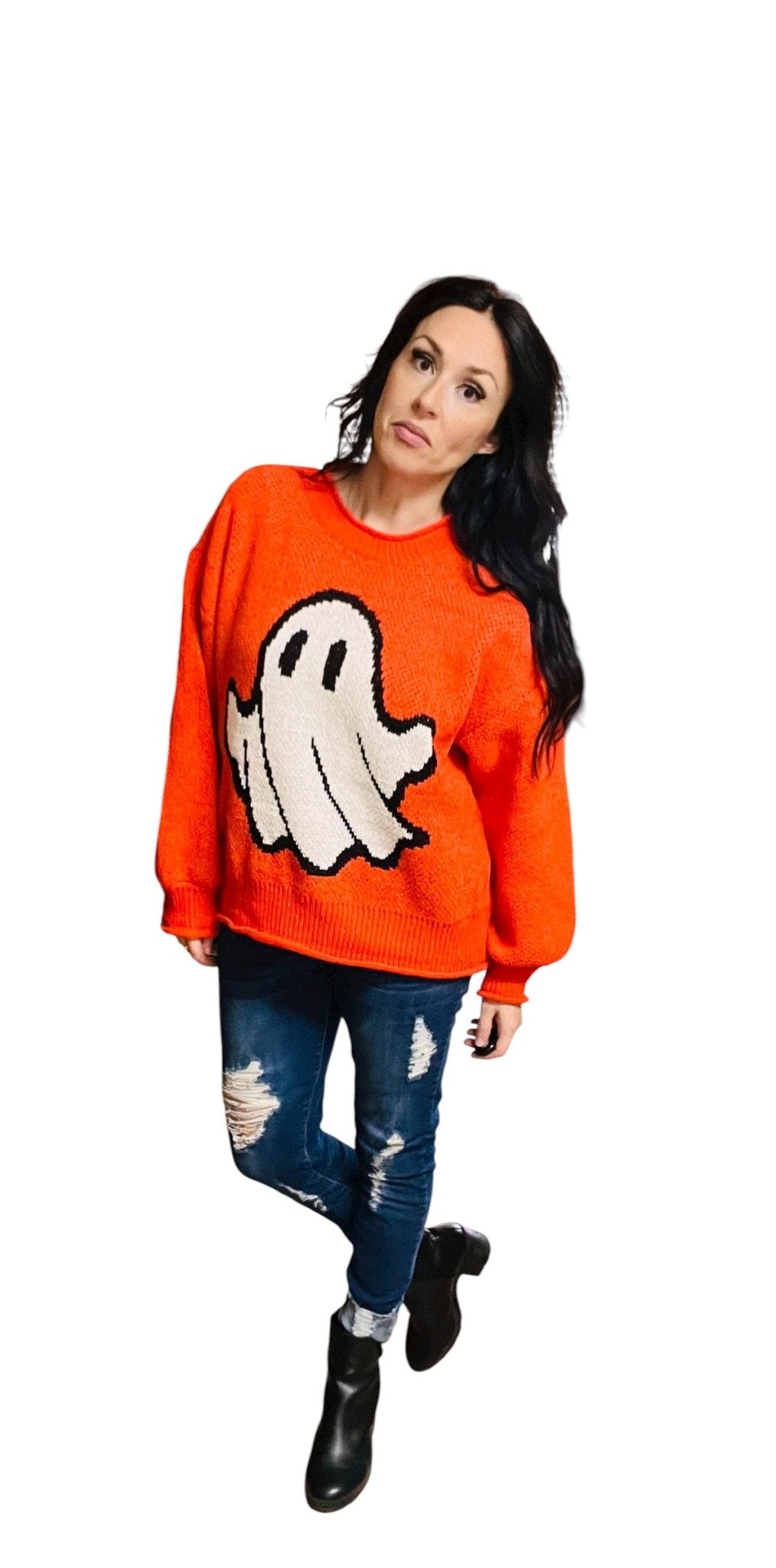 Person wearing an orange sweater with a ghost design on a white background