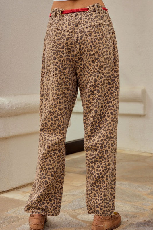 Leopard print wide leg cargo pants with relaxed streetwear styling and red drawstring detail