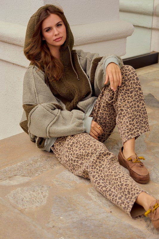 Leopard print wide leg cargo pants with relaxed streetwear styling and red drawstring detail