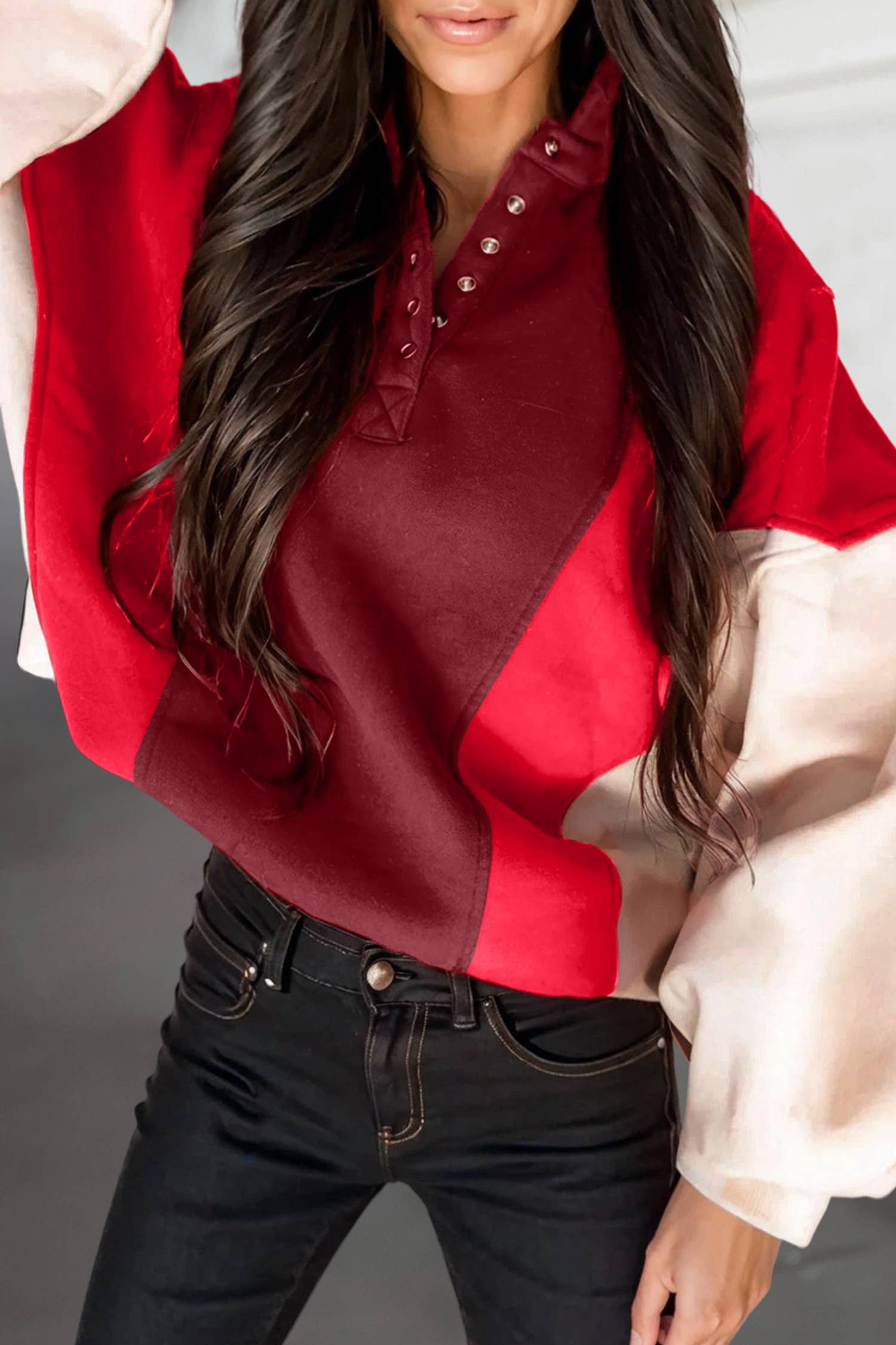 Person wearing a red and white checkered shirt with a neutral background