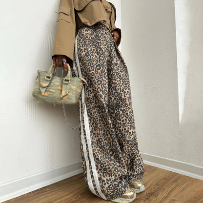 Leopard print wide leg track pants with side stripe detail and relaxed streetwear styling