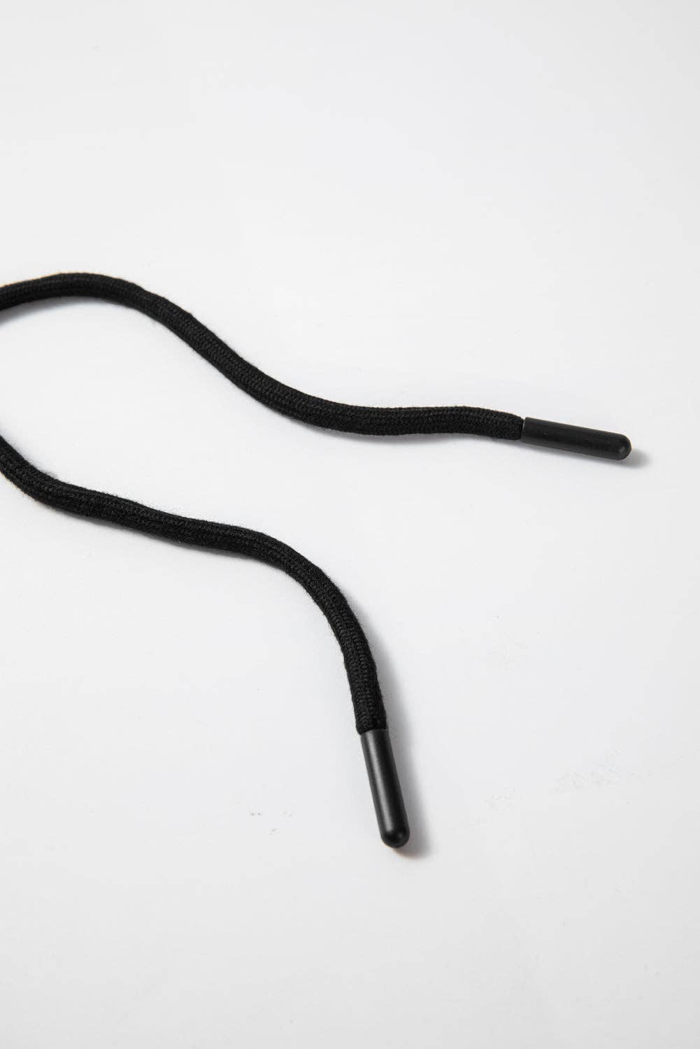 Black shoelace on a white background