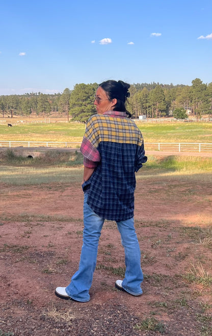 Oversized patchwork plaid flannel shirt styled with distressed denim jeans