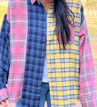 Oversized patchwork plaid flannel shirt styled with distressed denim jeans