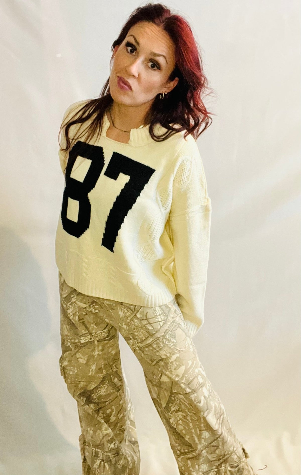 Cream oversized knit sweater with black 87 graphic and casual streetwear styling