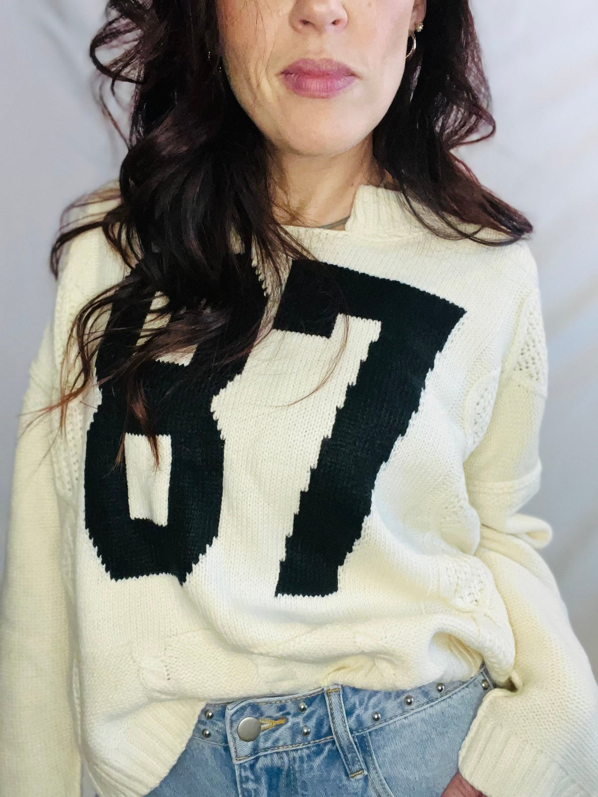 Cream oversized knit sweater with black 87 graphic and casual streetwear styling