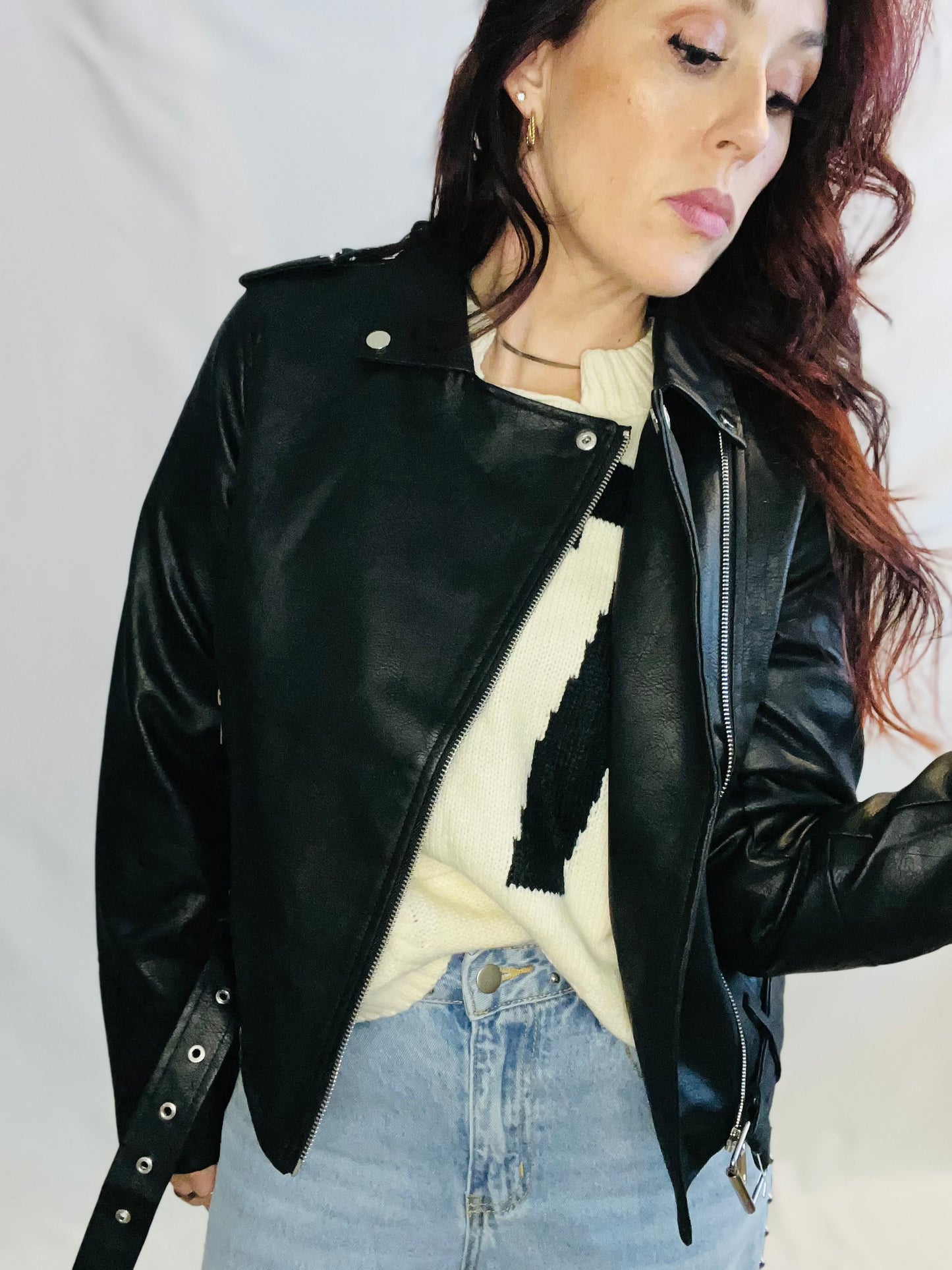 Black faux leather moto jacket with edgy minimalist streetwear styling for women