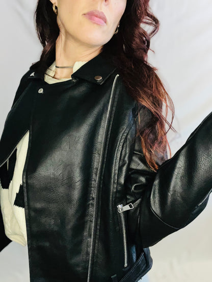 Black faux leather moto jacket with edgy minimalist streetwear styling for women