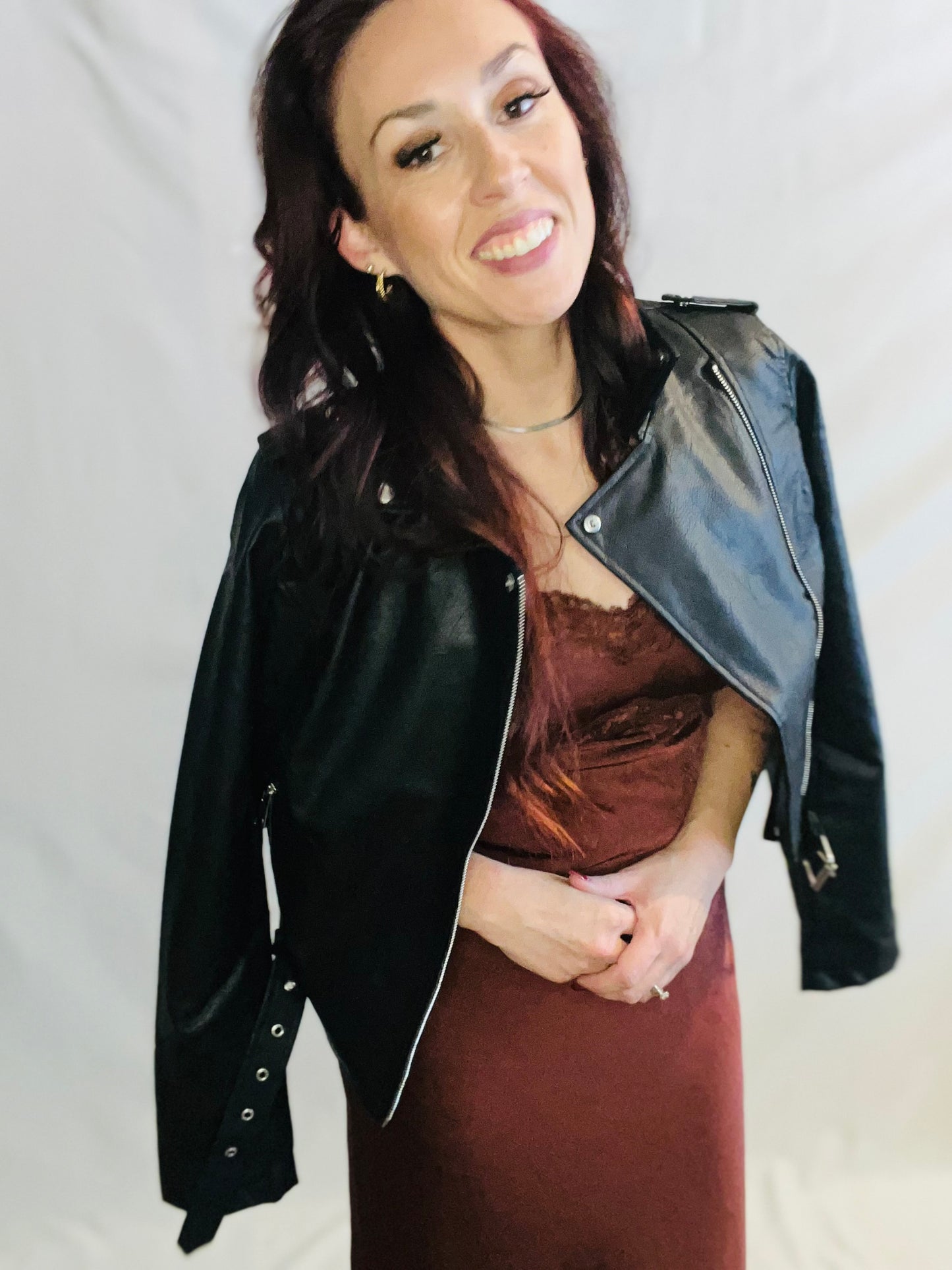 Black faux leather moto jacket with edgy minimalist streetwear styling for women