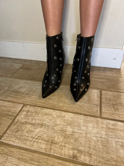 Black studded pointed toe ankle boots with edgy streetwear and modern grunge styling