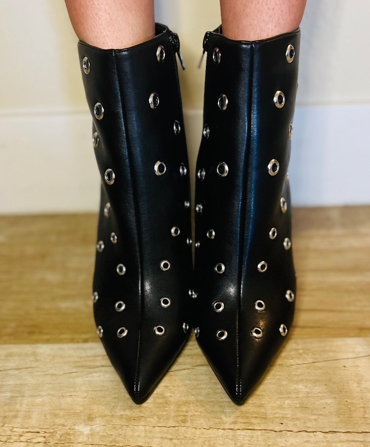 Black studded pointed toe ankle boots with edgy streetwear and modern grunge styling
