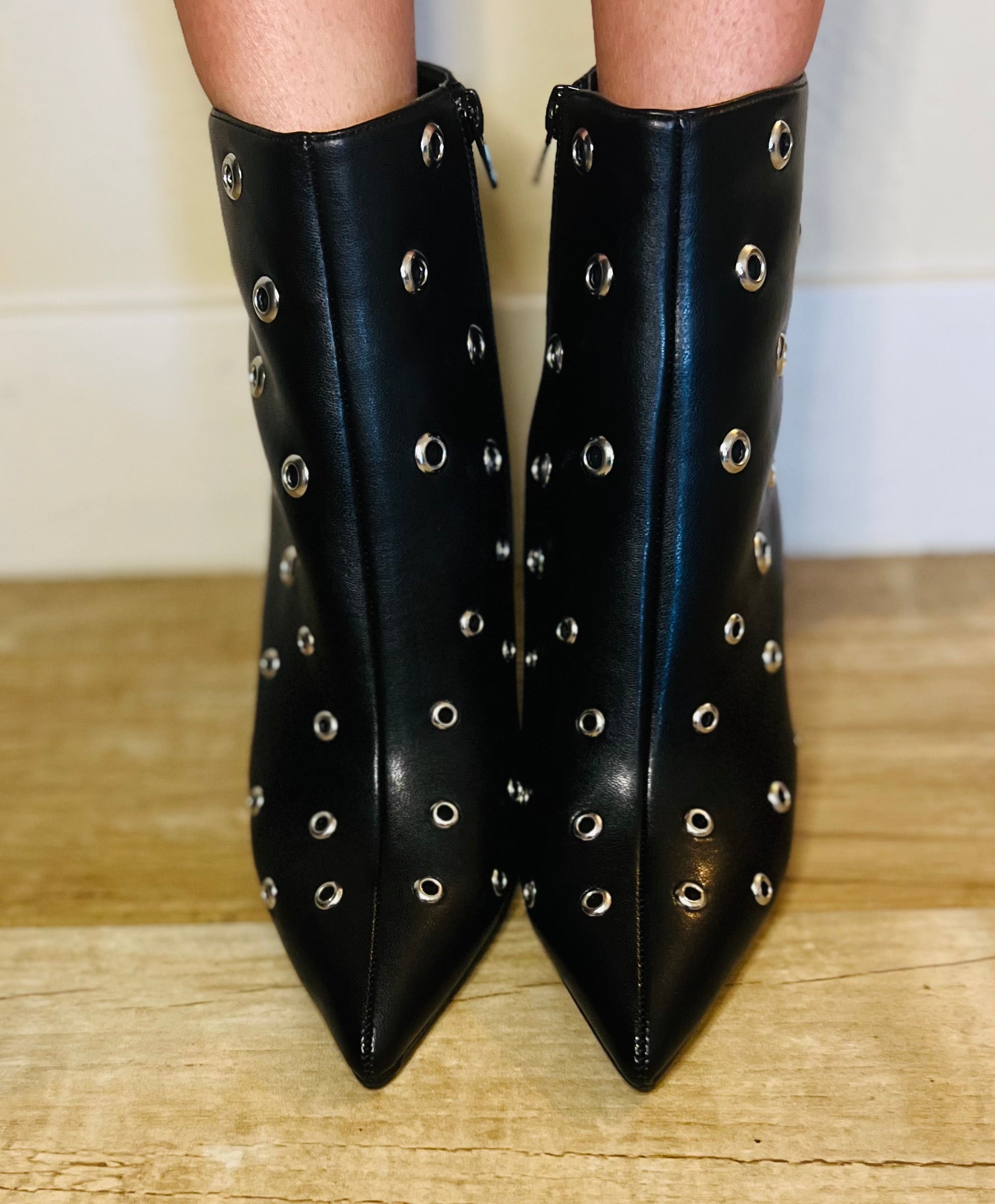Black studded pointed toe ankle boots with edgy streetwear and modern grunge styling