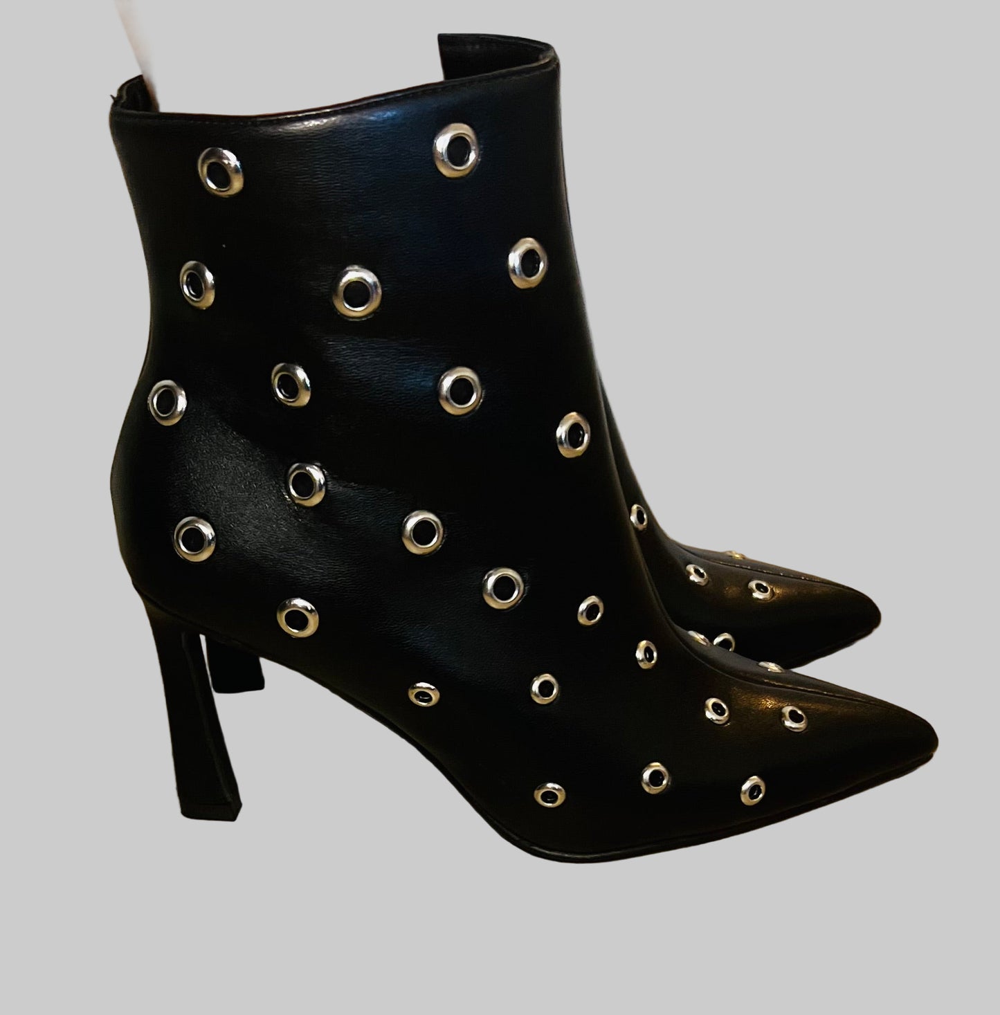 Black studded pointed toe ankle boots with edgy streetwear and modern grunge styling