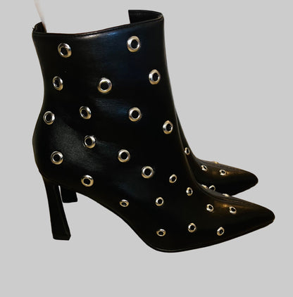 Black studded pointed toe ankle boots with edgy streetwear and modern grunge styling