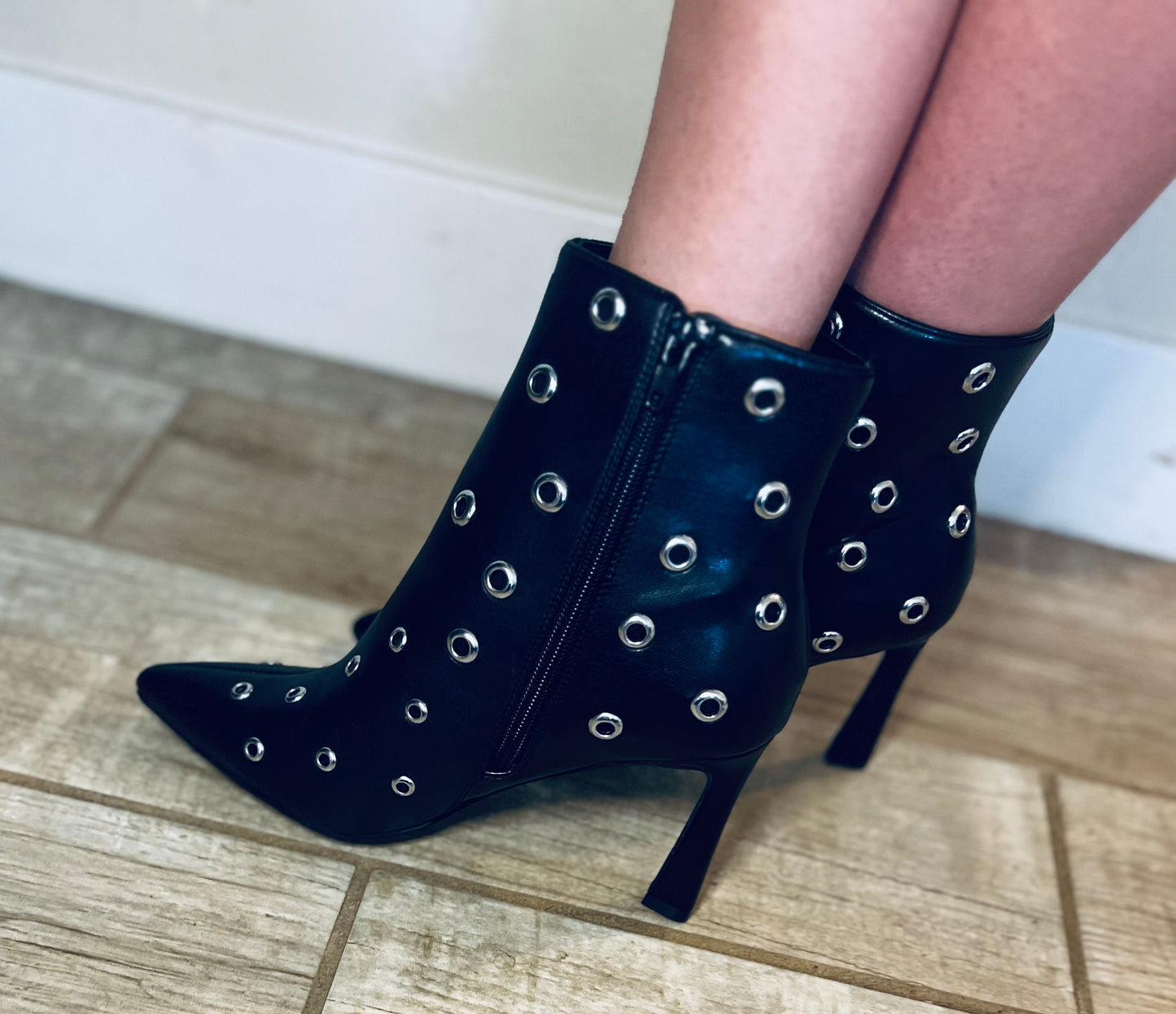 Black studded pointed toe ankle boots with edgy streetwear and modern grunge styling