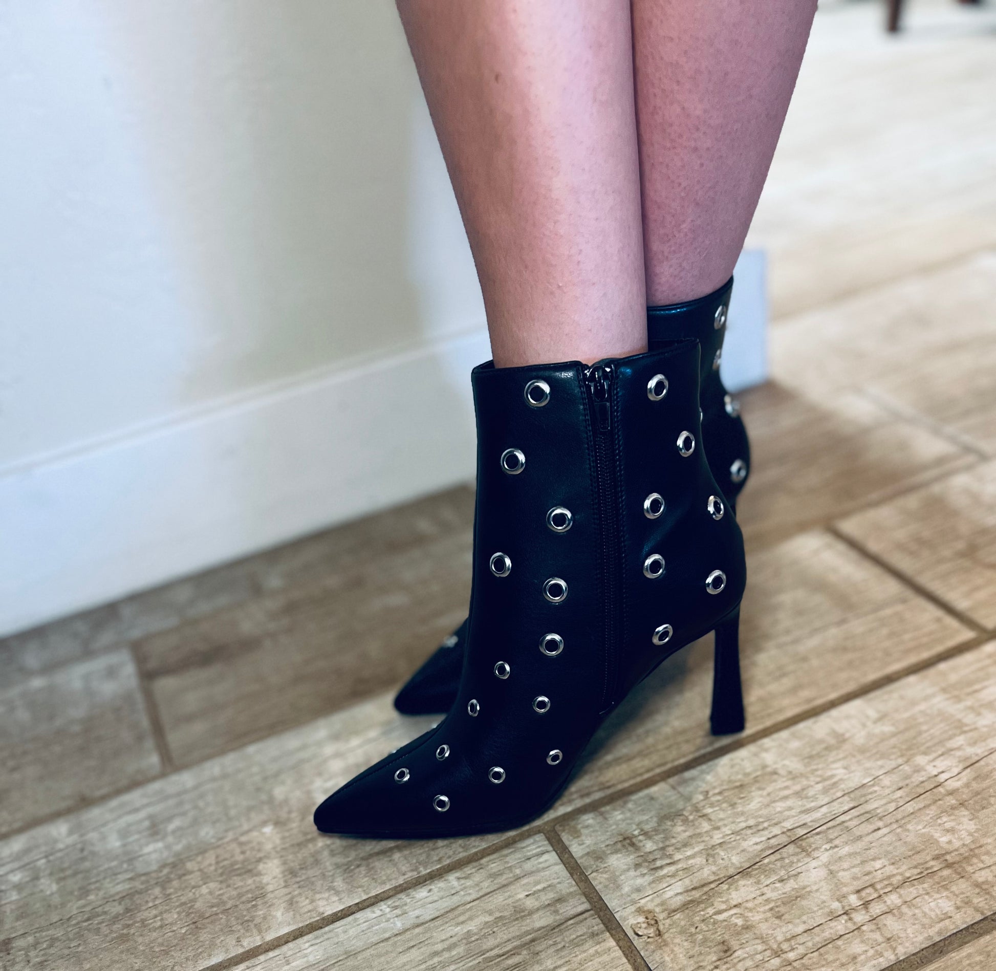 Black studded pointed toe ankle boots with edgy streetwear and modern grunge styling