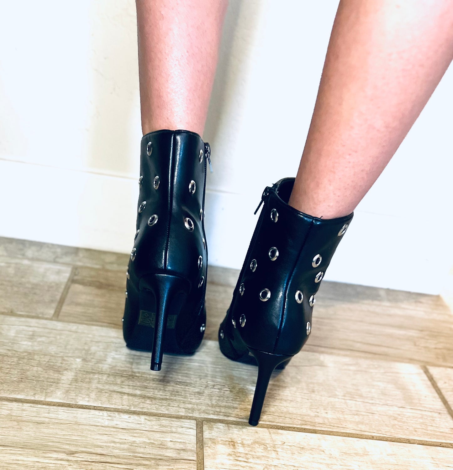 Black studded pointed toe ankle boots with edgy streetwear and modern grunge styling