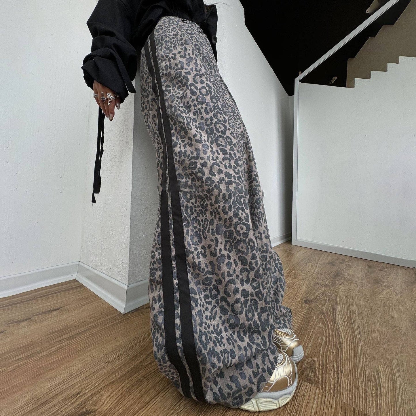 Leopard print wide leg track pants with side stripe detail and relaxed streetwear styling