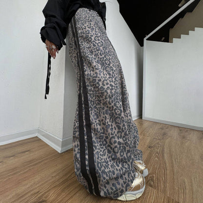 Leopard print wide leg track pants with side stripe detail and relaxed streetwear styling
