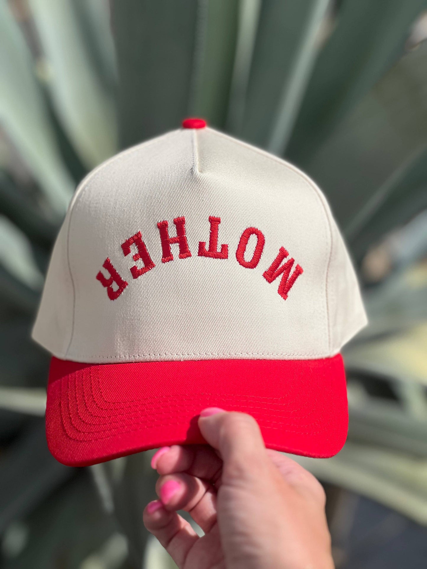 White and red embroidered Mother trucker hat with vintage casual streetwear styling