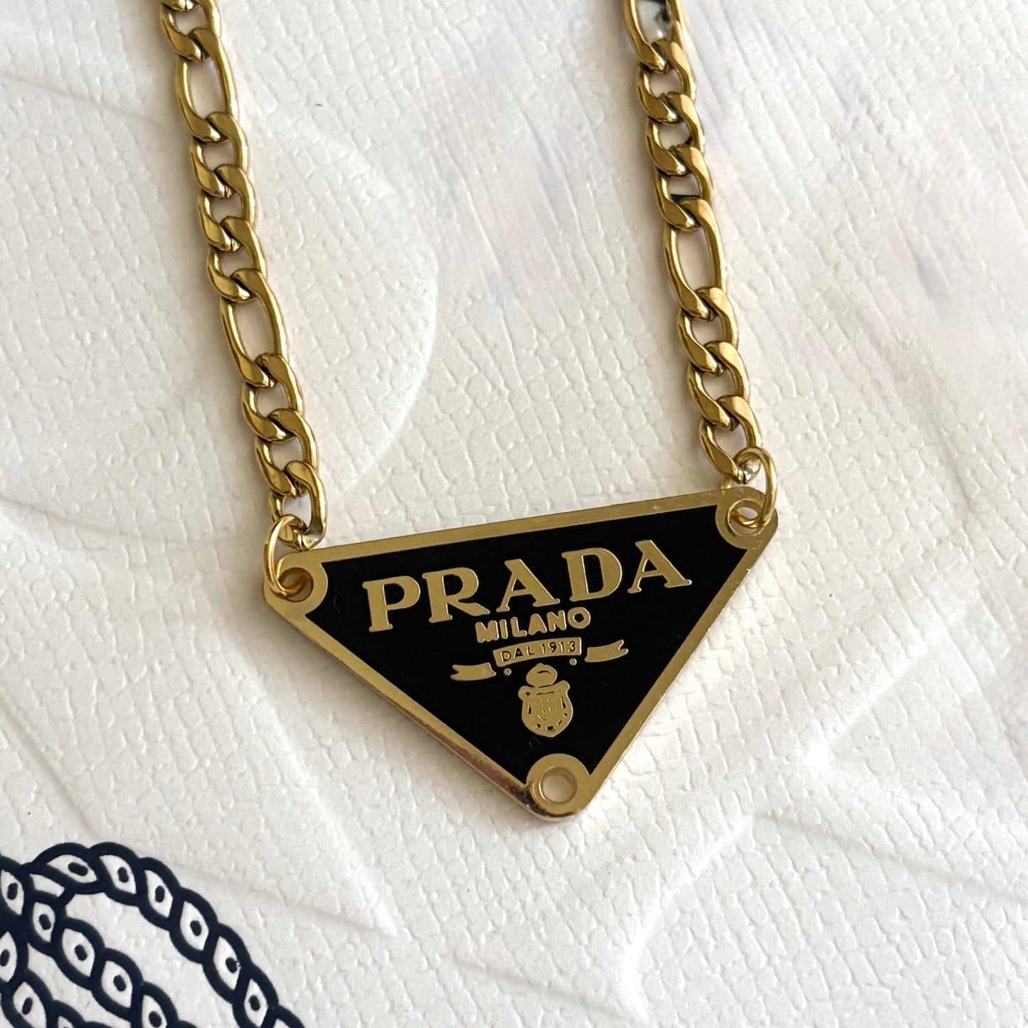 Repurposed luxury inspired triangle pendant necklace with gold chain and black enamel detail