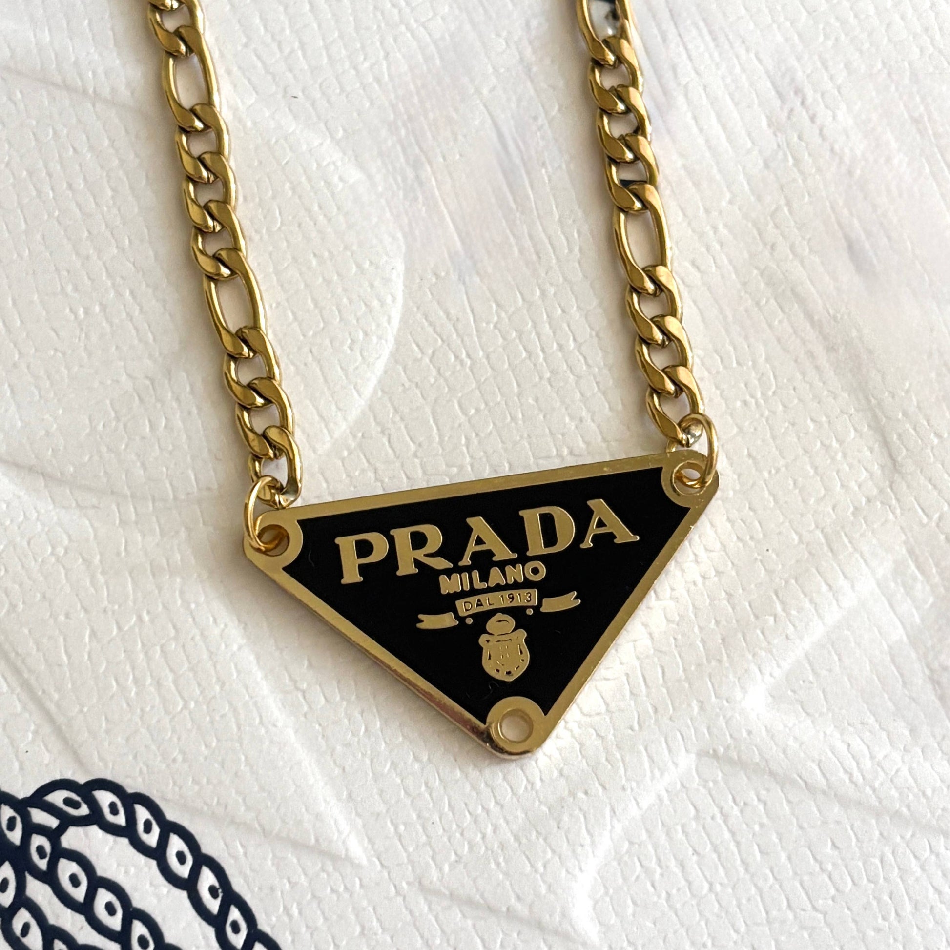 Repurposed luxury inspired triangle pendant necklace with gold chain and black enamel detail