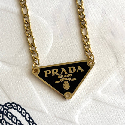 Repurposed luxury inspired triangle pendant necklace with gold chain and black enamel detail