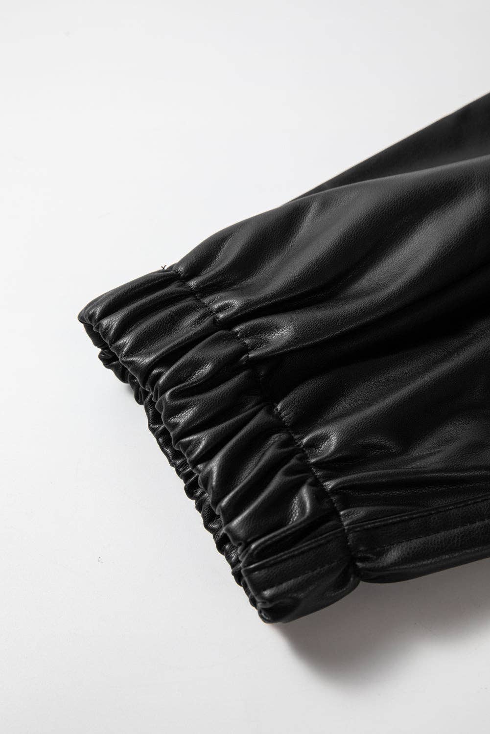 Black pleated fabric on a white background