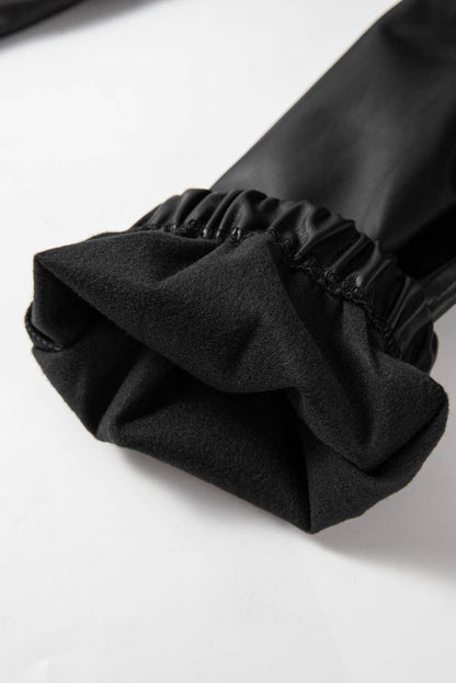 Close-up of a black sleeve with a ruffled cuff on a white background