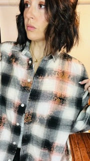 Person wearing a plaid shirt with a checkered pattern