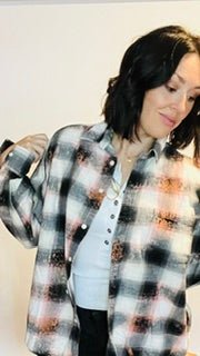 Person wearing a plaid shirt with a white background