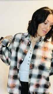 Person wearing a plaid shirt with a white background