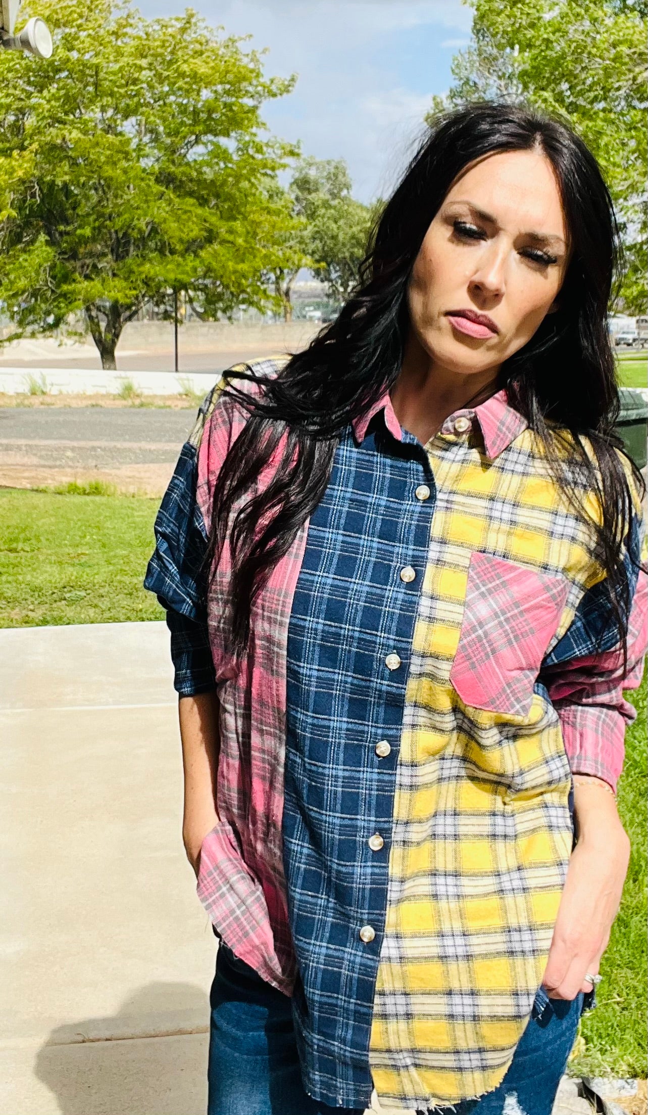 Oversized patchwork plaid flannel shirt styled with distressed denim jeans