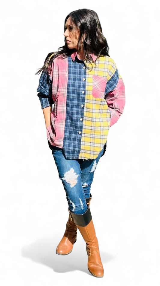 Woman wearing a colorful patchwork shirt and jeans on a white background