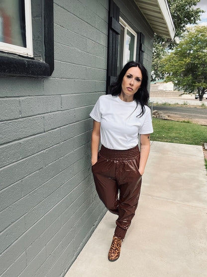 Brown faux leather jogger pants with relaxed elevated streetwear styling