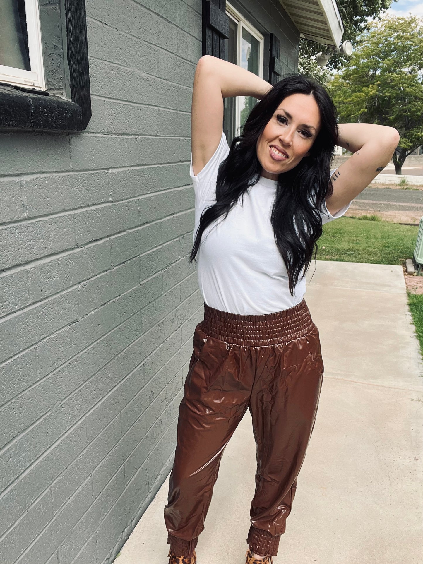Brown faux leather jogger pants with relaxed elevated streetwear styling