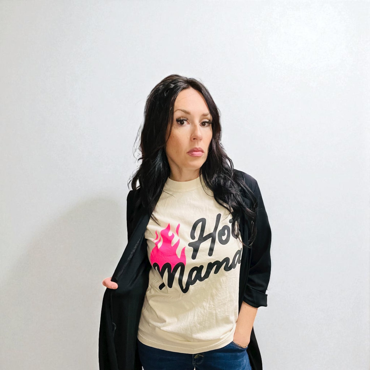 Woman wearing a 'Hot Mama' t-shirt against a plain background