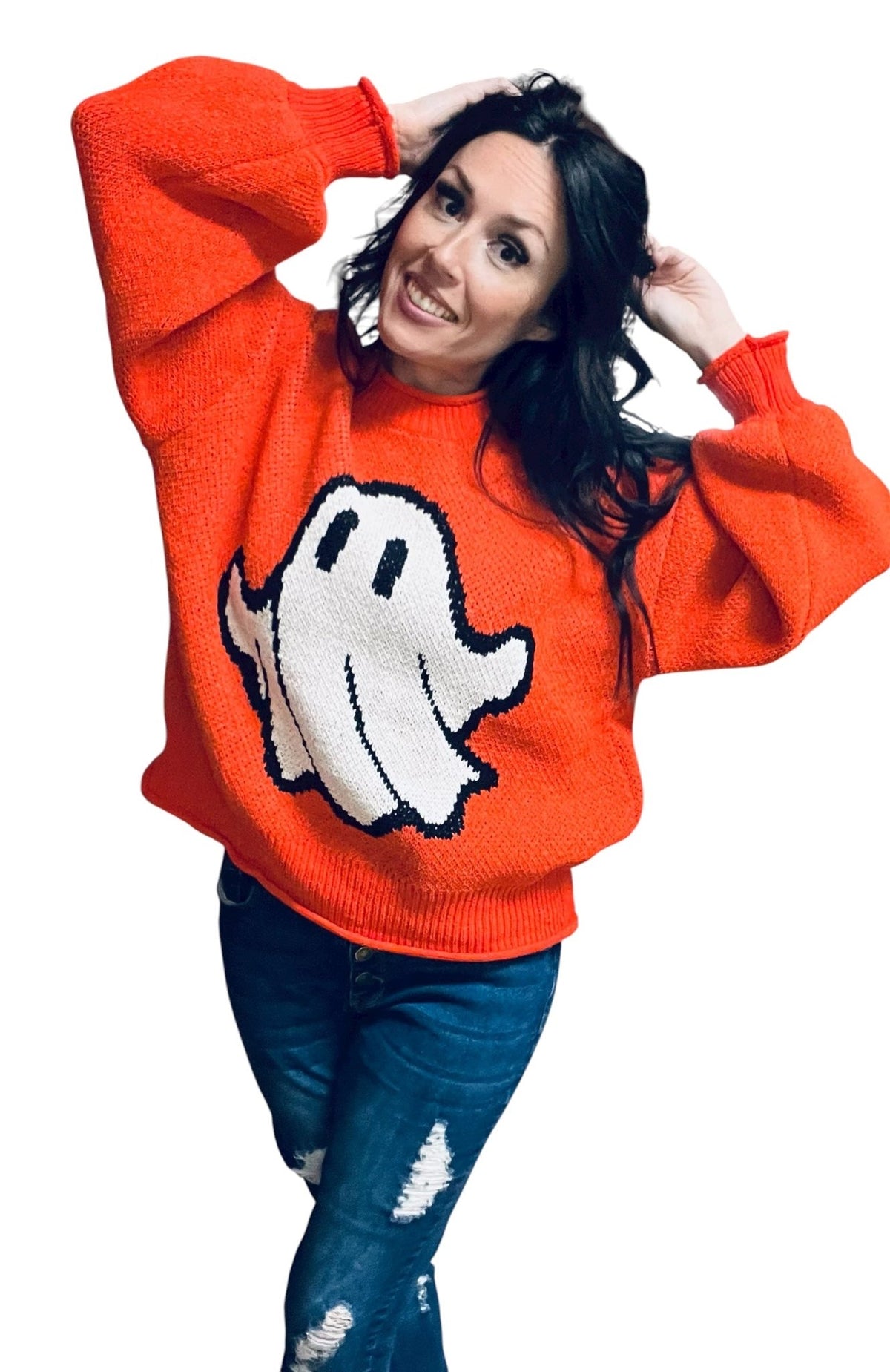 Person wearing an orange sweater with a ghost design on a white background