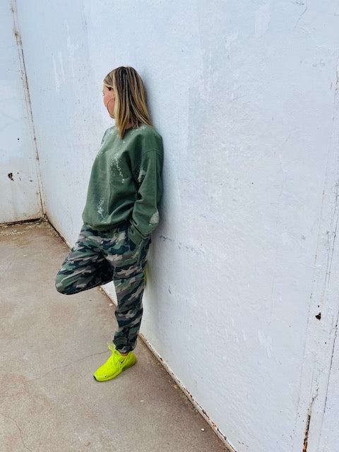 Olive green bleach wash oversized crewneck sweatshirt styled with camo pants