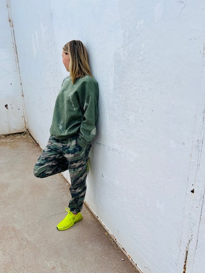 Olive green bleach wash oversized crewneck sweatshirt styled with camo pants