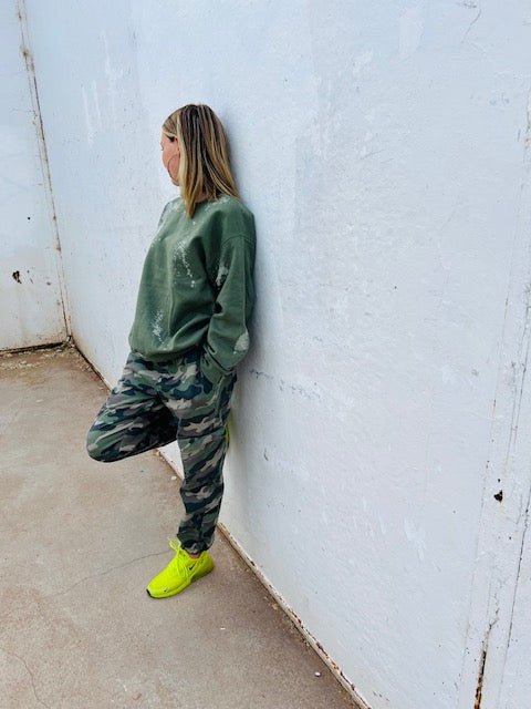 Olive green bleach wash oversized crewneck sweatshirt styled with camo pants