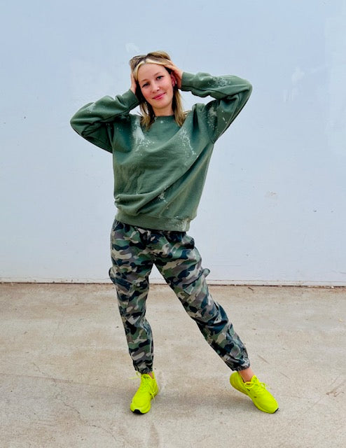 Olive green bleach wash oversized crewneck sweatshirt styled with camo pants