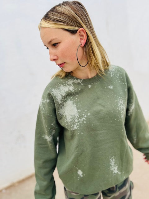 Olive green bleach wash oversized crewneck sweatshirt styled with camo pants