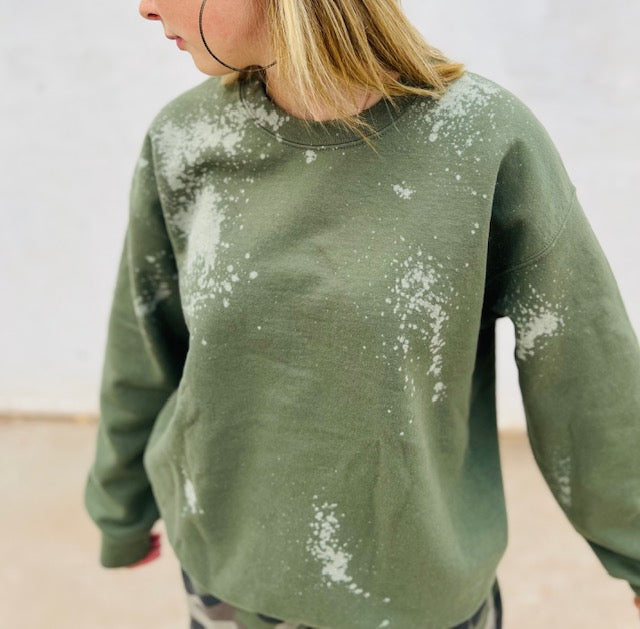 Olive green bleach wash oversized crewneck sweatshirt styled with camo pants