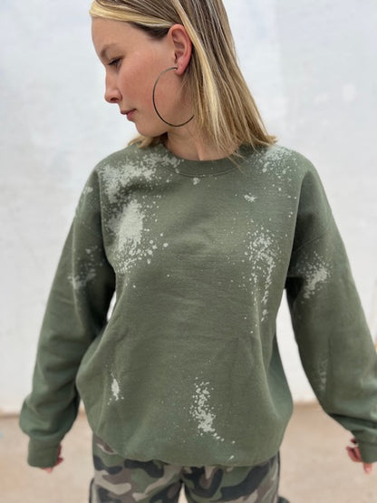 Olive green bleach wash oversized crewneck sweatshirt styled with camo pants