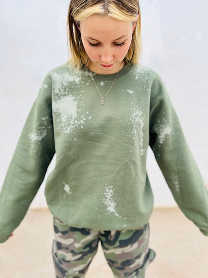 Olive green bleach wash oversized crewneck sweatshirt styled with camo pants
