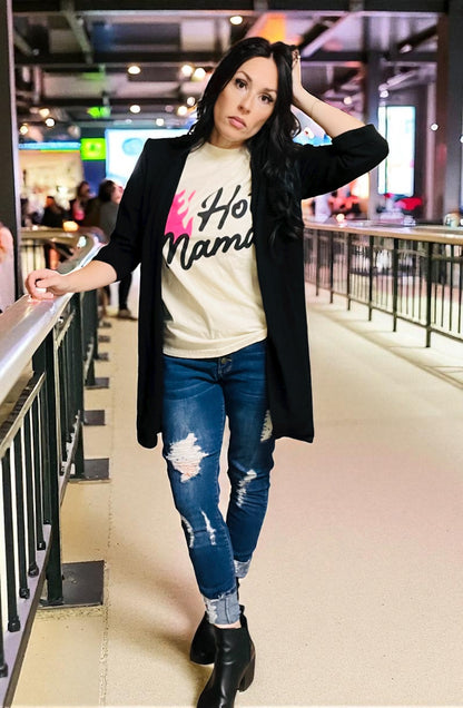 Woman wearing a graphic t-shirt and jeans in an indoor setting