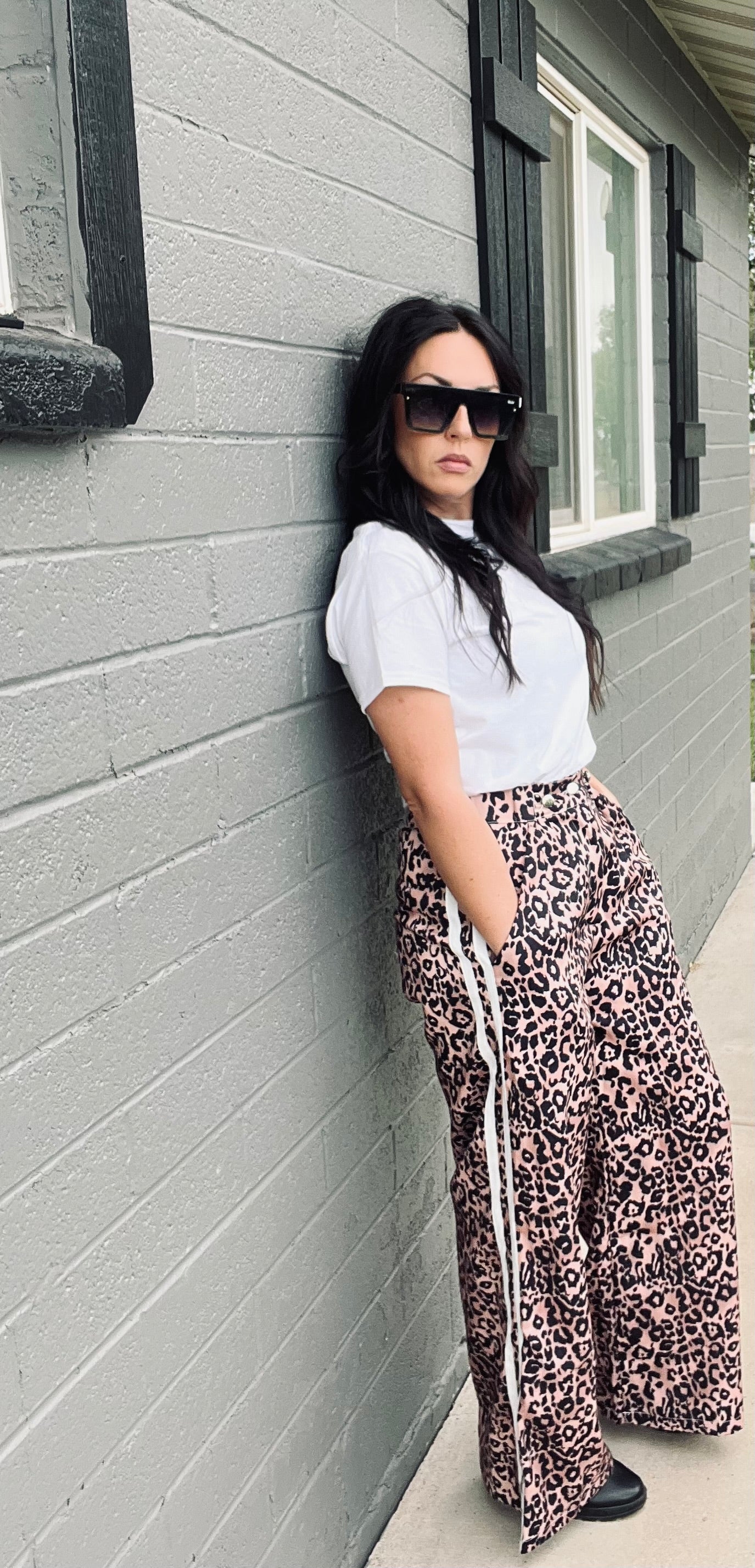 Leopard print wide leg track pants with side stripe detail and relaxed streetwear styling
